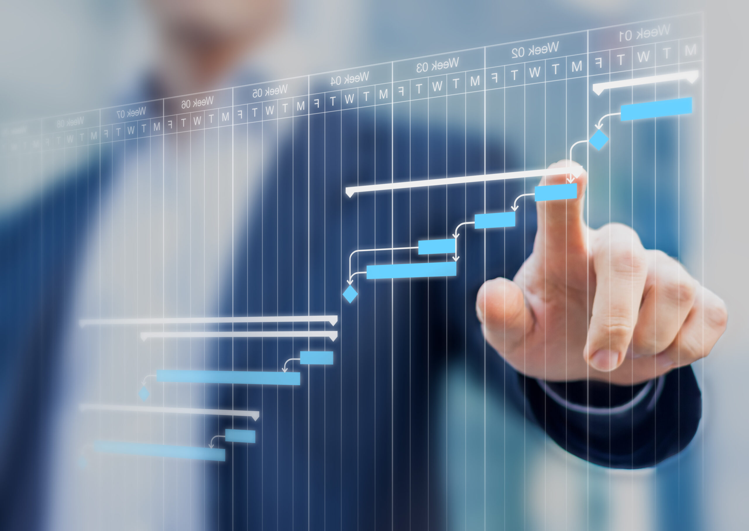 Project manager updating tasks and milestones progress planning with Gantt chart scheduling interface on a virtual screen